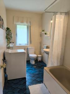 a bathroom with a tub and a toilet and a sink at Casa las granxias in El Escobal +39 photos