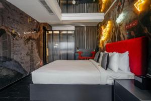 a bedroom with a large bed with a red headboard at SO City Hotel Adults Only in St. Julianʼs +37 photos