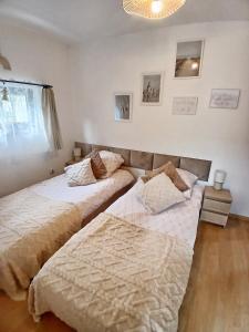 two beds sitting next to each other in a bedroom at Eleonor Accommodation in Liszki +16 photos