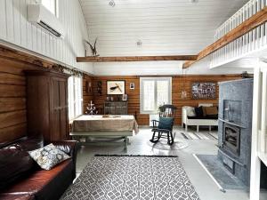 a living room with a couch and a fireplace at Villa Lempeänranta in Pello