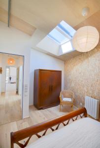 Zimmer mit einem Bett und einem Dachfenster in der Unterkunft Le Loft du Pré - Maison d'architecte - Le Mans in Le Mans