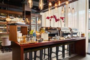 a bar in a restaurant with a counter with glasses at Best Western Hotel Norrkoping City in Norrköping +135 photos