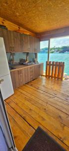 una cucina con pavimenti in legno e vista sull'acqua di River house Una a Kravlja