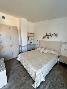 a bedroom with a large bed in a room at La Locanda di Piazza in Santa Teresa Gallura