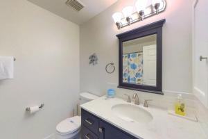 a bathroom with a sink and a mirror at Townhomes of Providence --- 9 John Hall Dr in Ocean View +18 photos