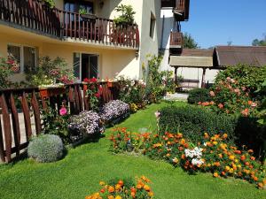 a garden of flowers in front of a house at Pensiunea Dyana in Moieciu de Jos