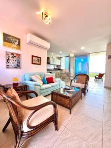 a living room with a couch and chairs at Beachfront Cabin with Private Pool in Puerto Colombia