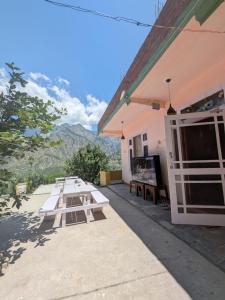 a group of picnic tables outside of a building at Kintsugi by Oztel in Kasol
