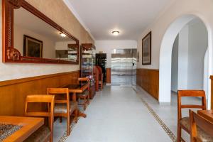 a restaurant with wooden tables and chairs and a mirror at Hotel El Campin in Bogotá