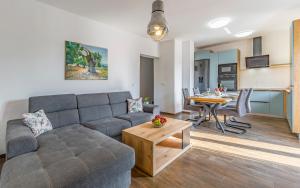 a living room with a couch and a table at house apartment Giuliano in Pula