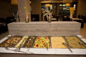 a buffet of different types of food on a table at Hotel Ibiza in Golem +28 photos