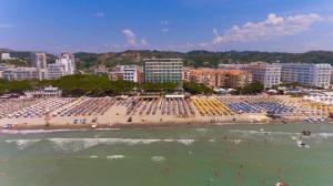 a beach with a crowd of people in the water at Hotel Ibiza in Golem