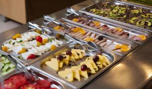 a buffet line with many different types of food at Hotel Ibiza in Golem