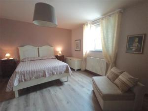 a bedroom with a bed and a chair and a window at La Solaria in Carmignano +64 photos