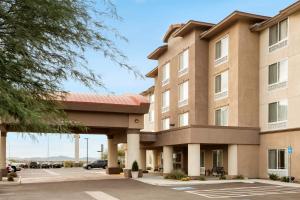 a rendering of the front of a hotel with a parking lot at Holiday Inn & Suites - Barstow, an IHG Hotel in Barstow