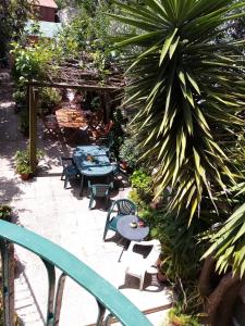 a patio with tables and chairs and plants at Metro Casa Música Apartments and Rooms in Porto