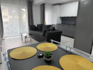 a living room with a table and a couch at Serenity retreats VRT in Şelimbăr +1 photo