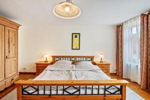 a bedroom with a bed and two night stands at Ferienwohnung Sonnenschein in Naumburg