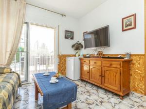 a living room with a television on a wooden dresser at Villa Sueño I by Interhome in L'Ametlla de Mar