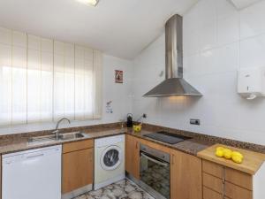 a kitchen with a sink and a washing machine at Villa Sueño IV by Interhome in L'Ametlla de Mar