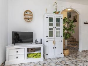 a white cabinet with a television on top of it at Villa Sueño IV by Interhome in L'Ametlla de Mar +21 photos