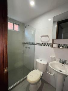 a bathroom with a toilet and a shower and a sink at Apto Grand- Ithiel in Barranquilla +22 photos