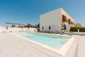 a swimming pool in front of a building at Kairos San Vito Lo Capo in San Vito lo Capo