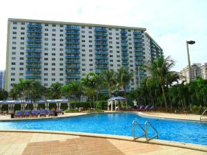 a swimming pool in front of a large building at Penthouse Ocean Reserve in Miami Beach