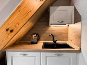 a kitchen with a sink in a tiny house at Apartment Penia 2-3 by Interhome in Canazei +39 photos