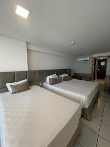 Ένα ή περισσότερα κρεβάτια σε δωμάτιο στο Beira mar - Beach Class Executive 105