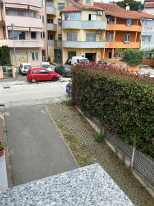 a parking lot with a red car and some buildings at Apartman Romina in Pula +4 photos