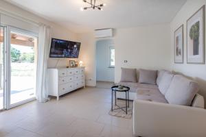 a living room with a couch and a tv at Villa Antonia, a beautiful pool villa in a large 1900 sqm garden in Modrušani