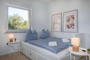 a bedroom with a bed with blue pillows and a window at Villa Antonia, a beautiful pool villa in a large 1900 sqm garden in Modrušani +26 photos
