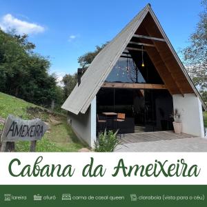 a small house with a roof on a porch at Cabanas Bela Vista in Rolante