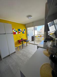 a room with a kitchen and a dining room at Estudio mondrian in Playa del Ingles +14 photos