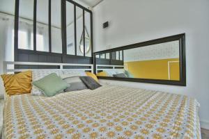 a bedroom with a bed and a large window at Au Sauna de Maintenon in Maintenon