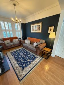 a living room with a couch and a rug at The Ivy on Adelaide in Belfast
