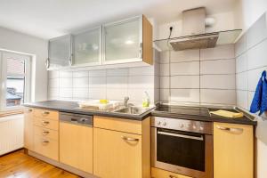 a kitchen with a sink and a stove at Ferienwohnung Kolibri in Naumburg