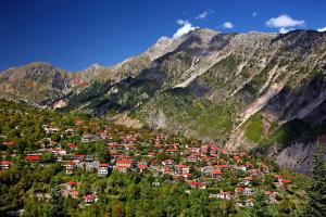 a group of houses on a hill in front of a mountain at Ξενώνας στα Θεοδώριανα 2 - Guesthouse Theodoriana 2 in Theodóriana