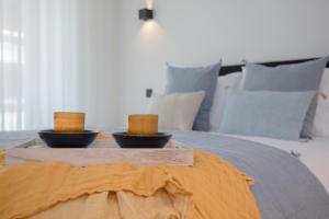 a tray with two candles on top of a bed at Liiiving in Gaia - Beach Seaside Apartment in Vila Nova de Gaia