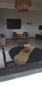 a living room with a table with a cup on it at Sítio Chã do Cajá in Sao Benedito do Sul