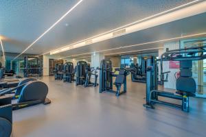a gym with lots of treadmills and machines at Cond Bayline - Corvina - SPA - POOL - GYM - BEACH - BY BEDZY in Armação de Pêra