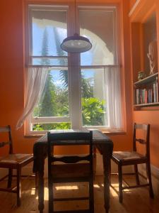a table and two chairs in front of a window at Artists Seaside Sanctuary in St. Leonards