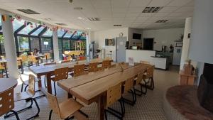 a dining room with a large wooden table and chairs at Hostel Rennes in Rennes