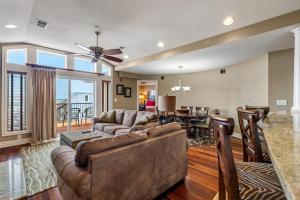 a living room with a couch and a dining room at CSC4L - Surfs Up in Kill Devil Hills