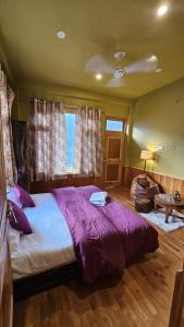 a bedroom with a large bed and a window at Kintsugi by Oztel in Kasol