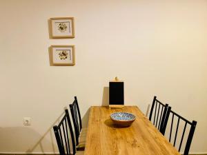 a dining room table with chairs and a bowl on it at Sophia's Apartments - Lipsi Rosemary in Lipsoi