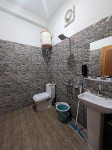 a bathroom with a toilet and a sink at Kintsugi by Oztel in Kasol +30 photos