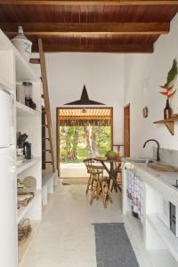 a kitchen with a table and a dining room at Casa Beija-Flor Algodões in Marau