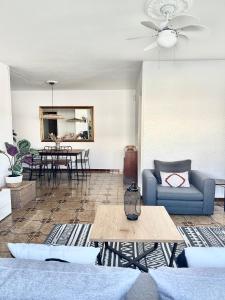 a living room with a couch and a table at Chalet con piscina privada cerca del mar in Cala'n Bosch +21 photos